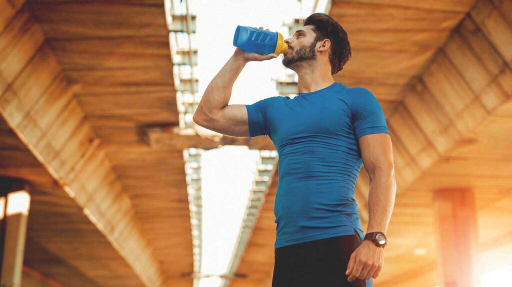 man drinking pre workout supplement 1296x728 1